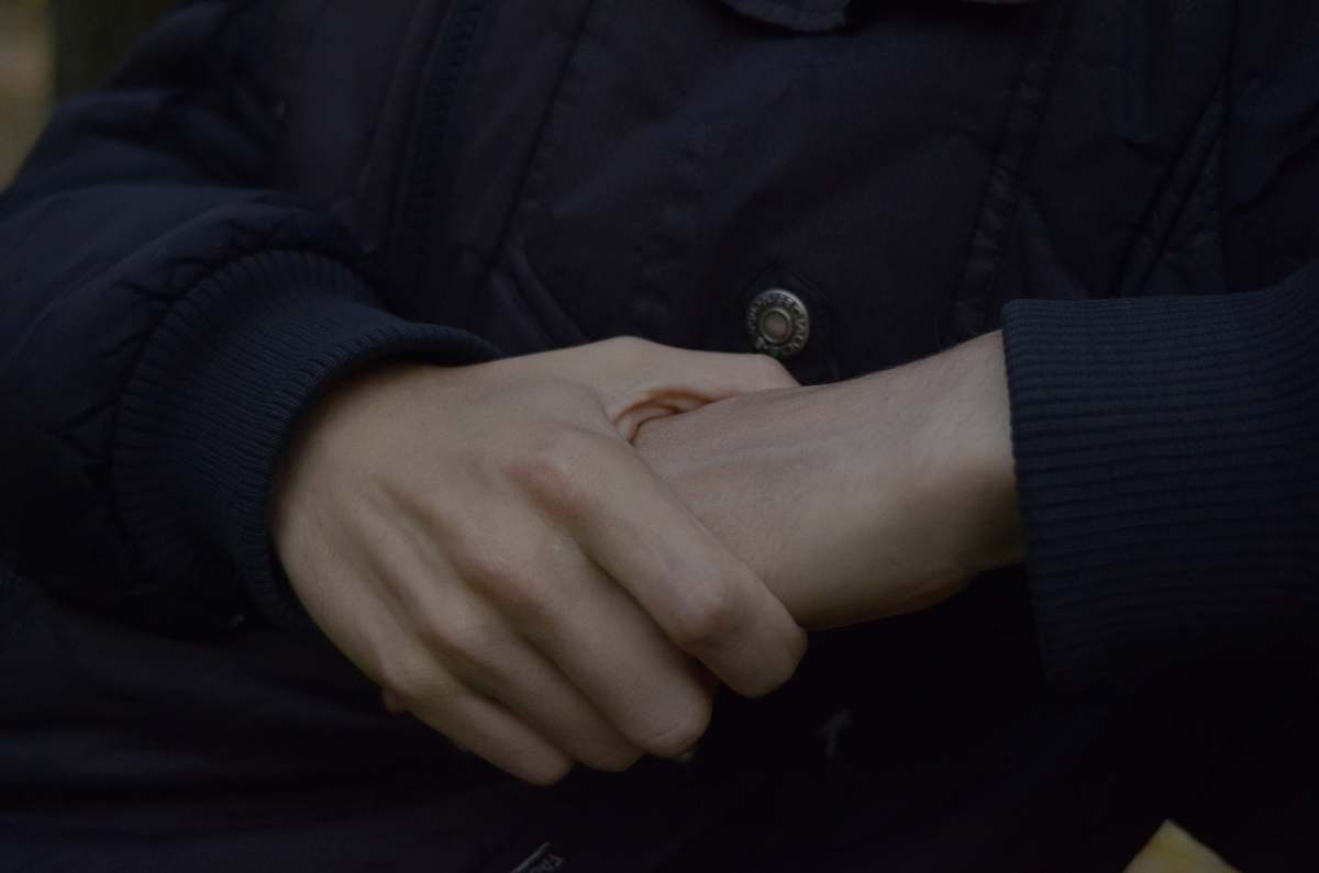 holding hands person wearing black top grey